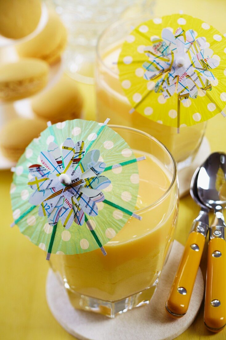 Flower shapes punched out of maps decorating cocktail umbrellas