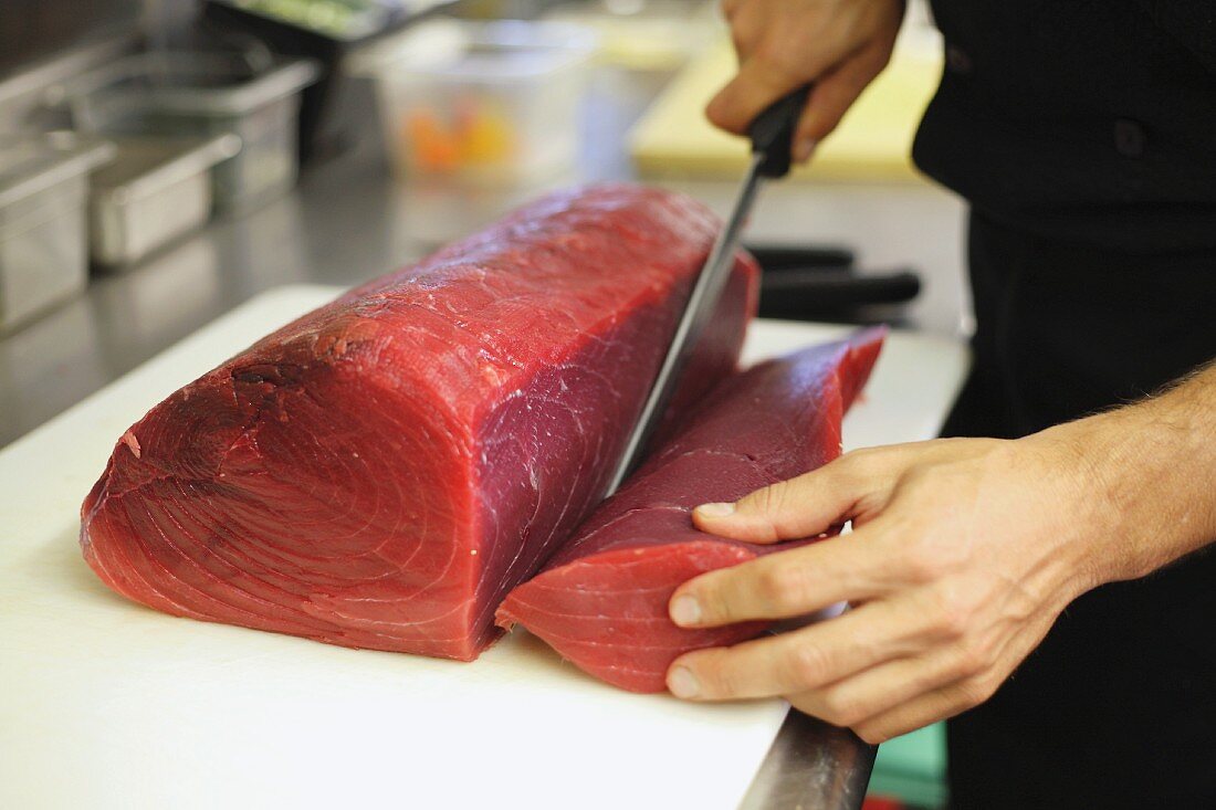 Chef Cutting Raw Tuna Steak