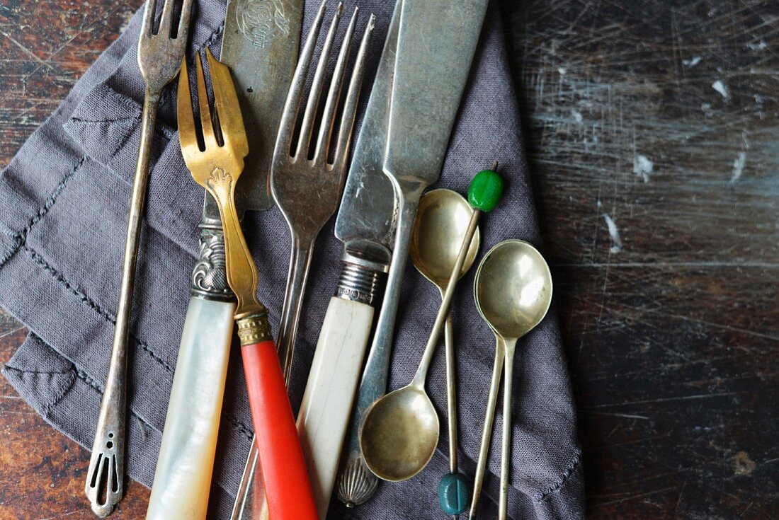 vintage knives and forks on a linen napkin