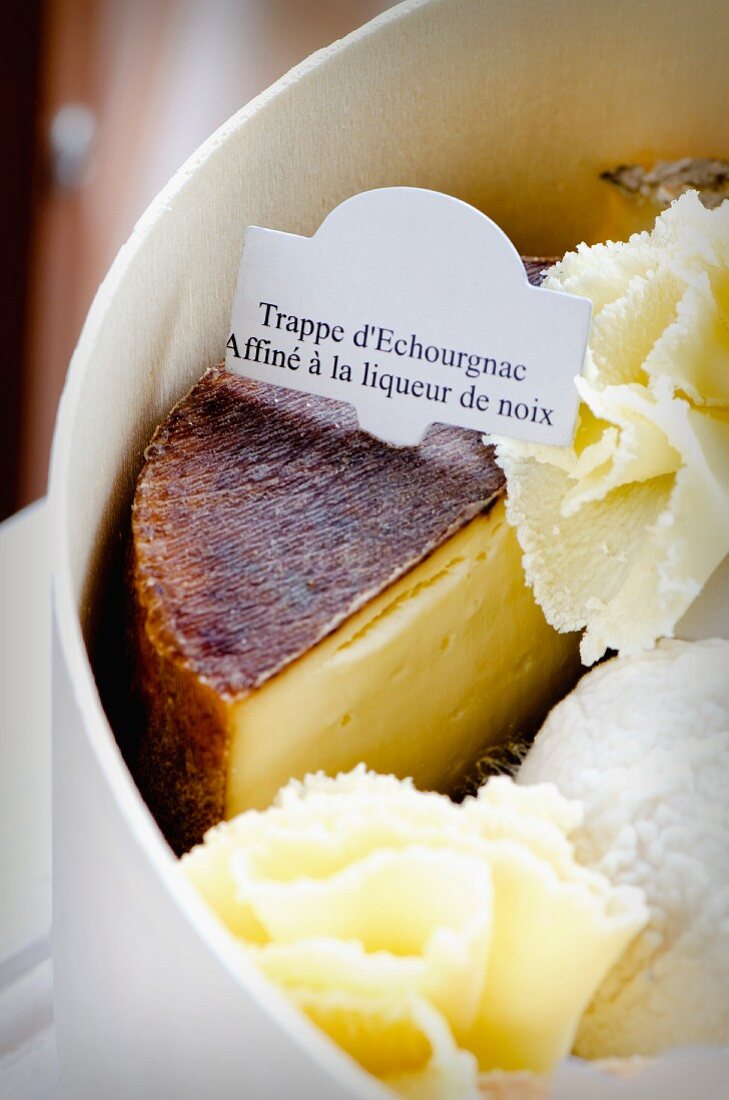 Assorted types of French cheese in a woodchip box