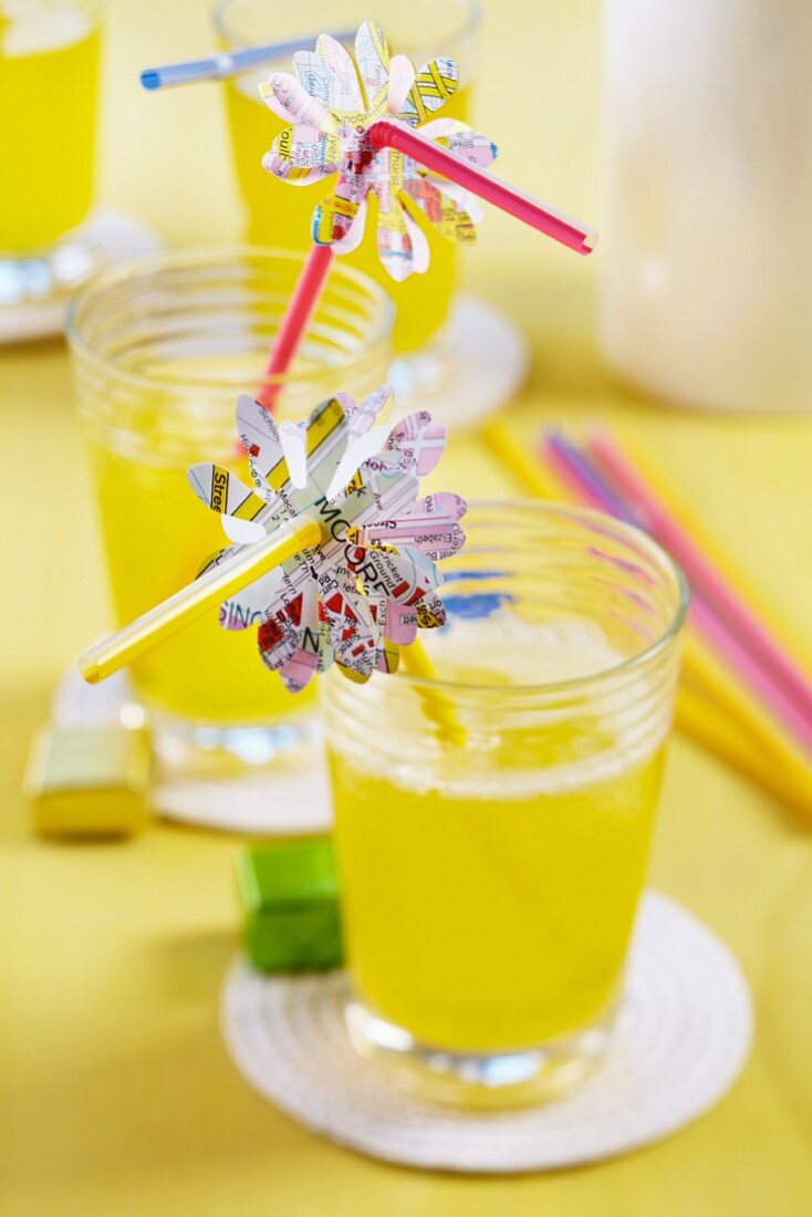 Flower shapes punched out of map decorating drinking straws for party