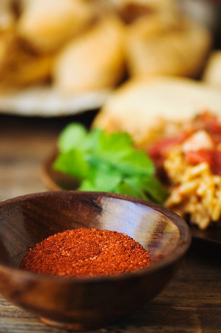 A Mexican spice mixture in a wooden bowl