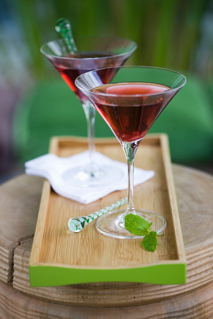 Cocktails in martini glasses on a tray