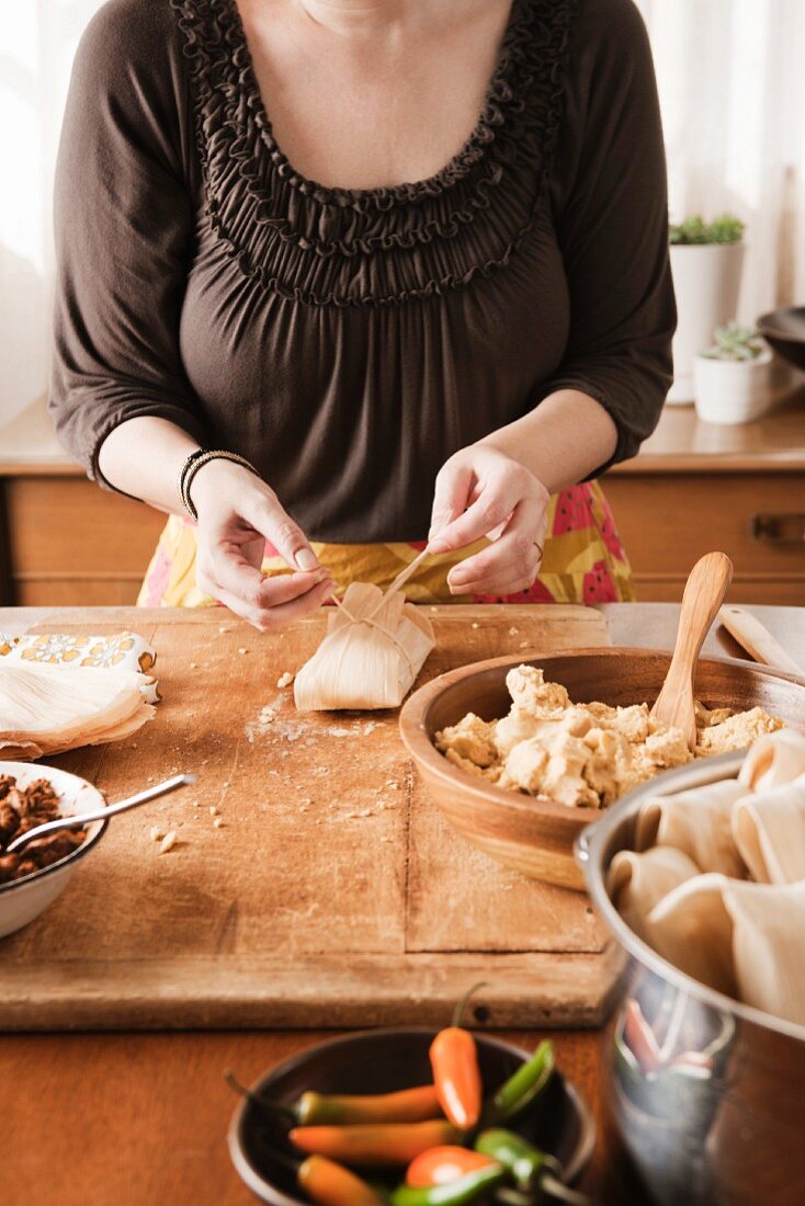 A woman preparing tamales