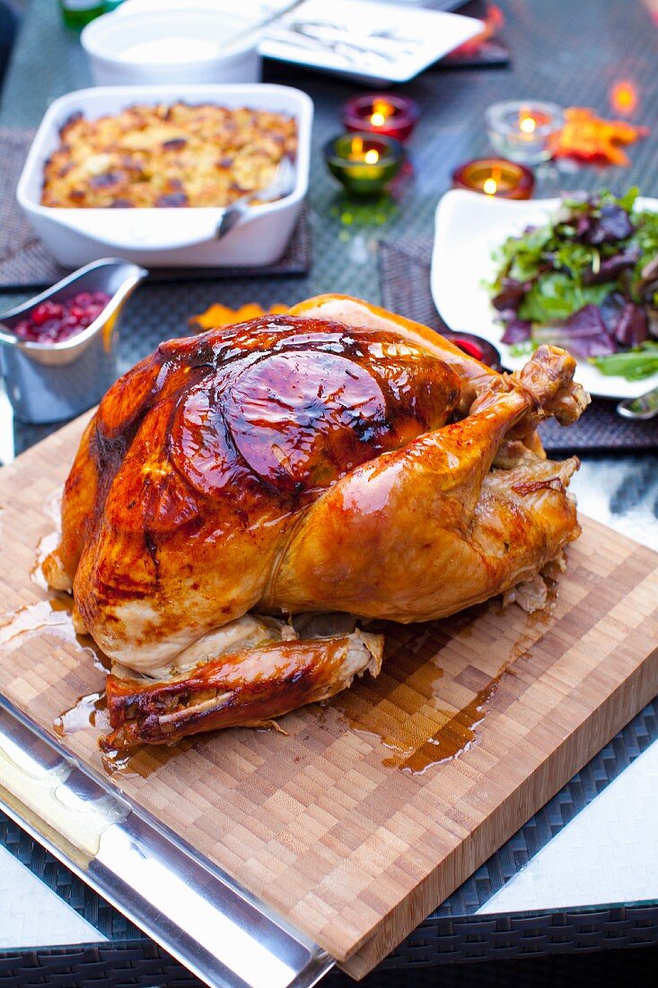 A roast turkey on wooden board