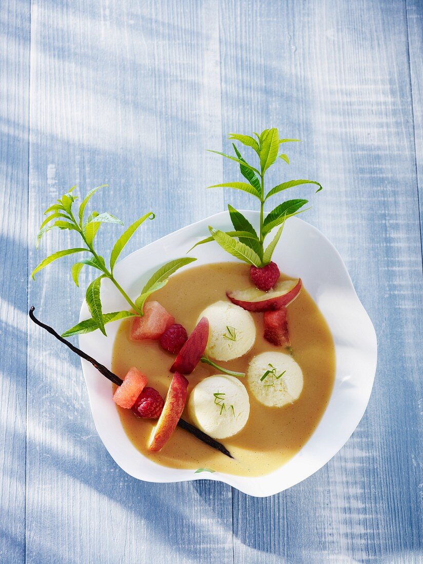 Cold soup with herb ice cream and fruit kebabs