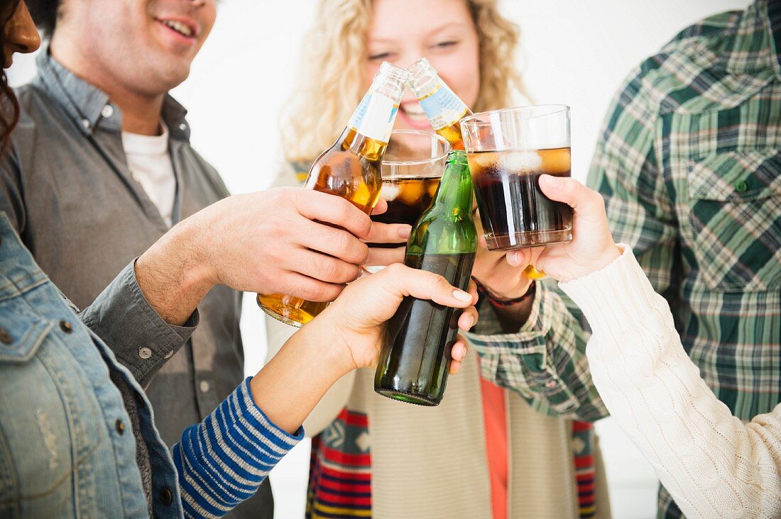 Young people at a party clinking glasses together