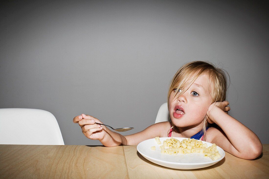 Young Blonde Girl Eating Pasta