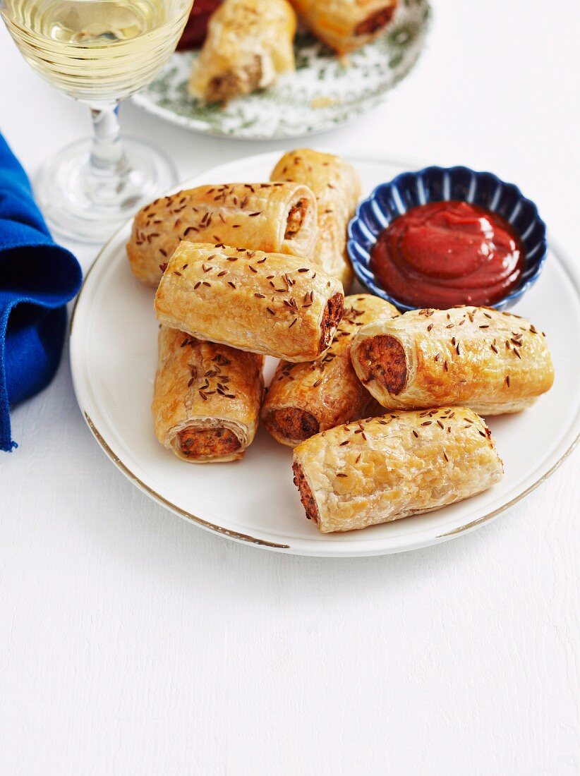 Puff pastry rolls filled with minced meat and served with a tomato sauce