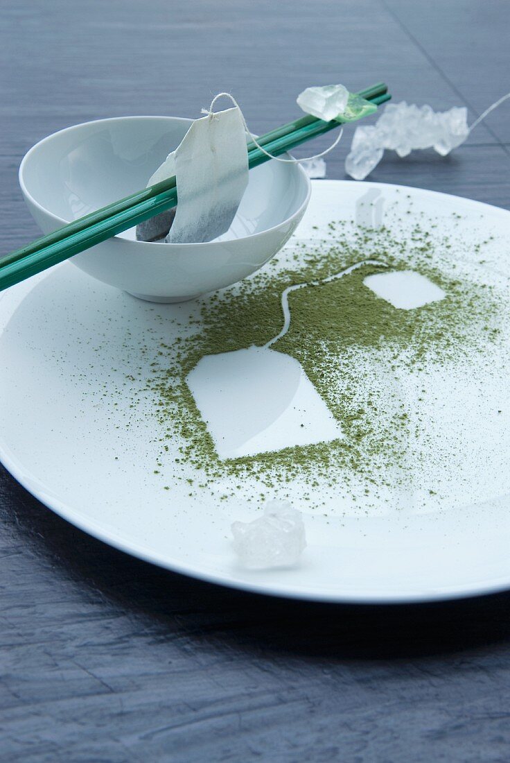 An oriental place setting and chopsticks with a teabag print in green tea powder