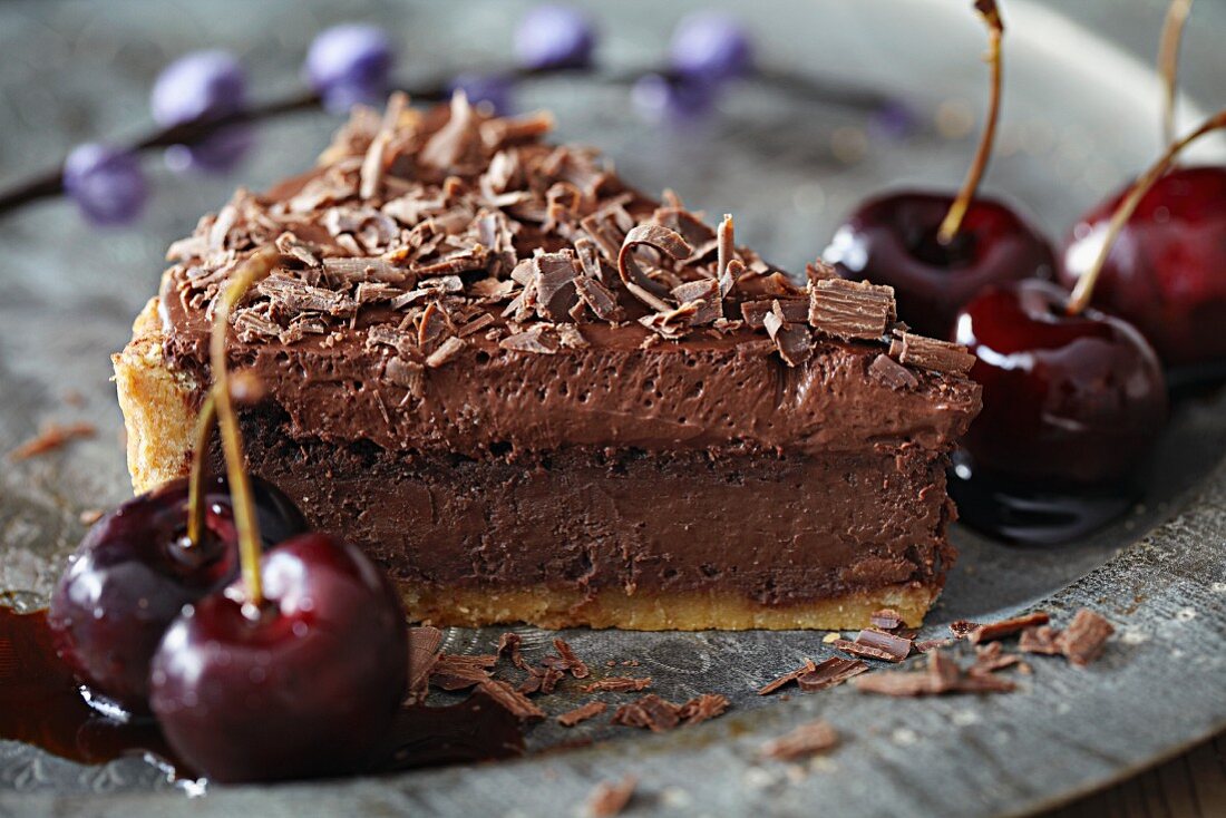 A slice of chocolate tart with cherries