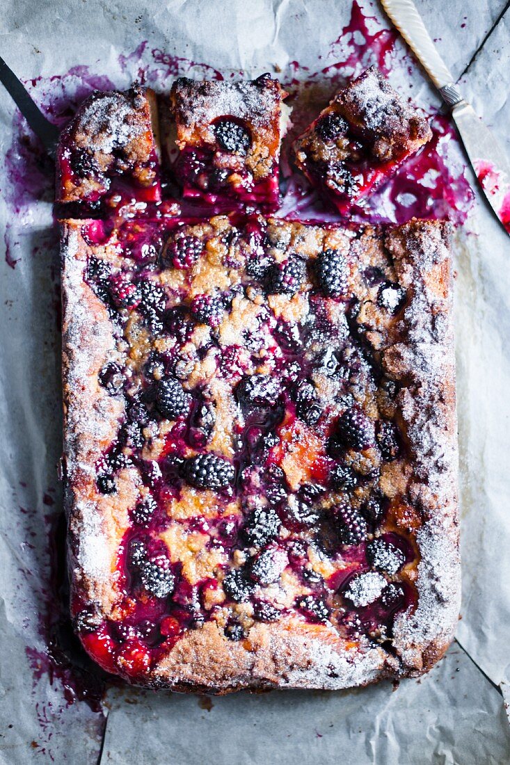 Blackberry cake, one slice removed