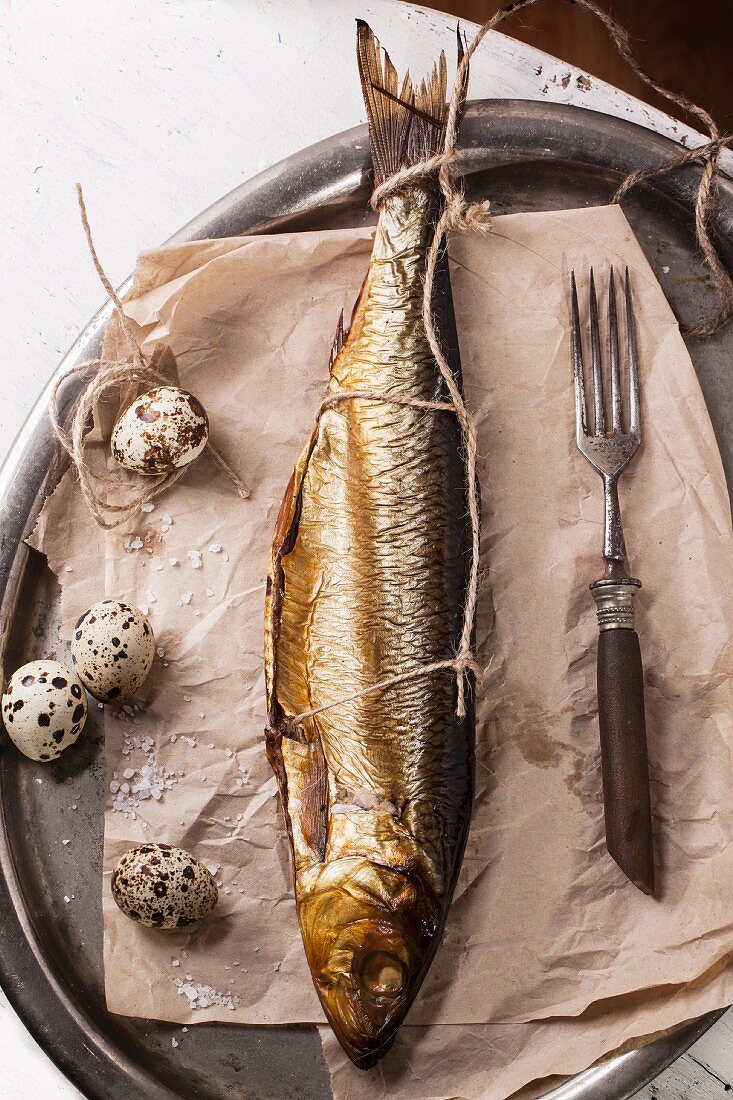 Smoked fish and quail eggs on vintage tray