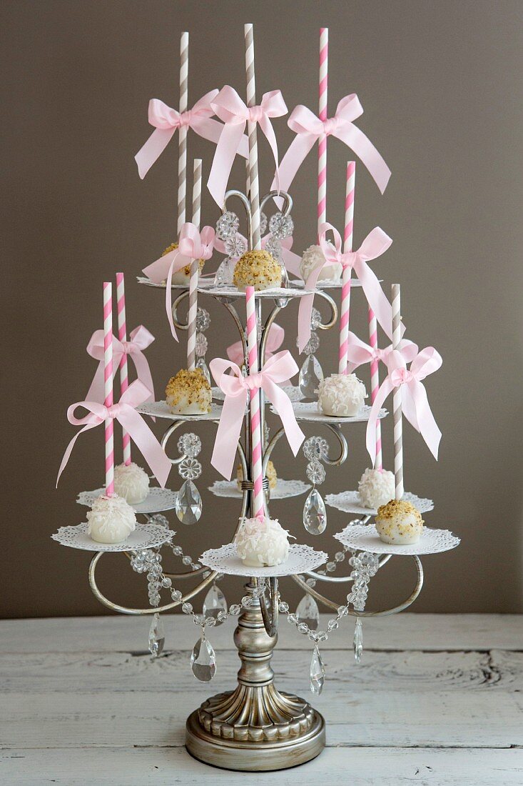 Assortment of Cake Popsicles with Striped Straws on Ornate Tiered Display