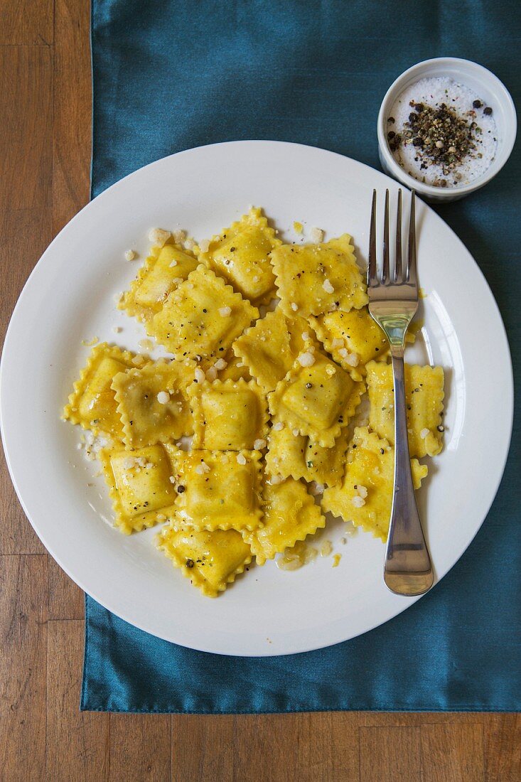 Cheese Raviolis on White Plate with Fork, High Angle View
