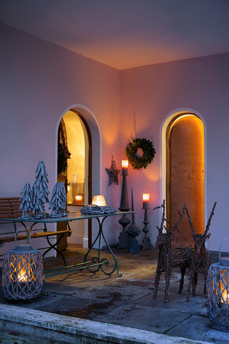 Roofed porch lit by lanterns and candles