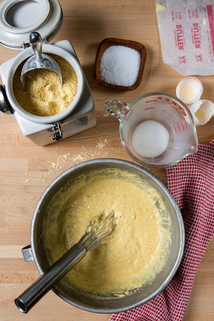 Raw cornbread dough and ingredients