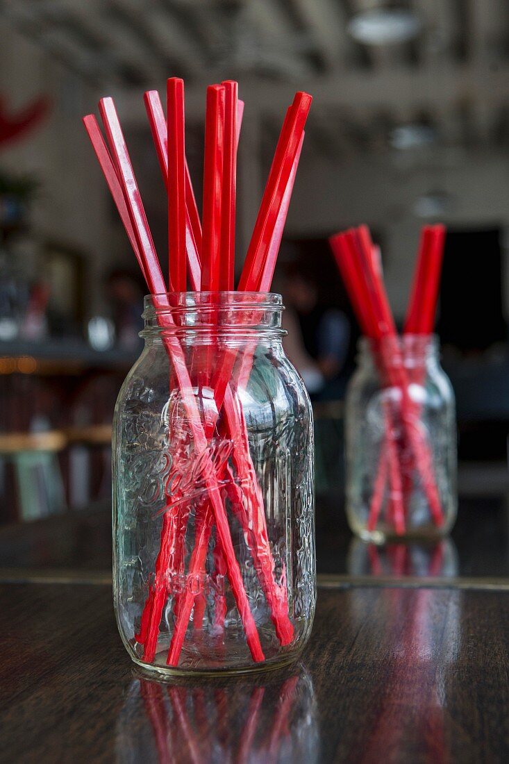 Red straws in screwtop jars