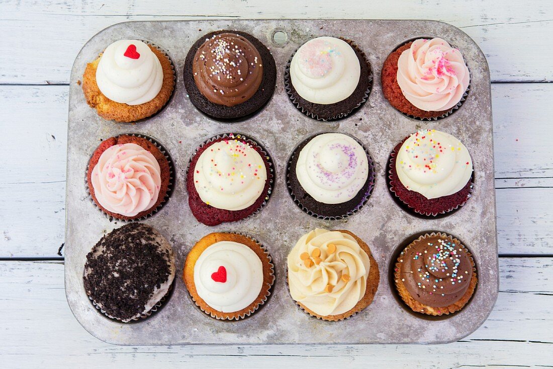 Various cupcakes in a muffin tin