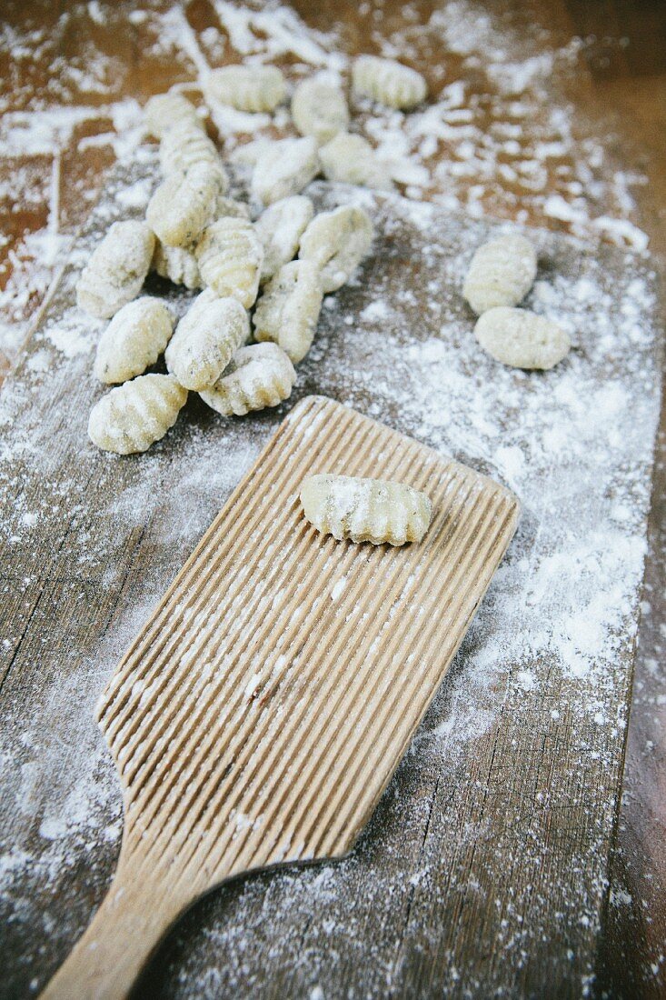 Uncooked gnocchi on a floured work surface