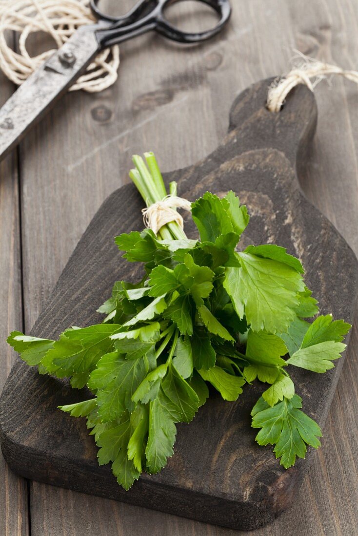 A bunch of smooth parsley on a wooden board