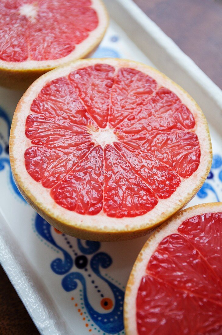 Three pink grapefruit halves