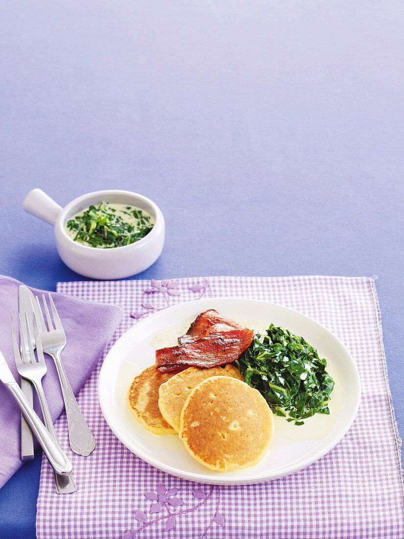 Polenta pancakes with bacon and a chard medley