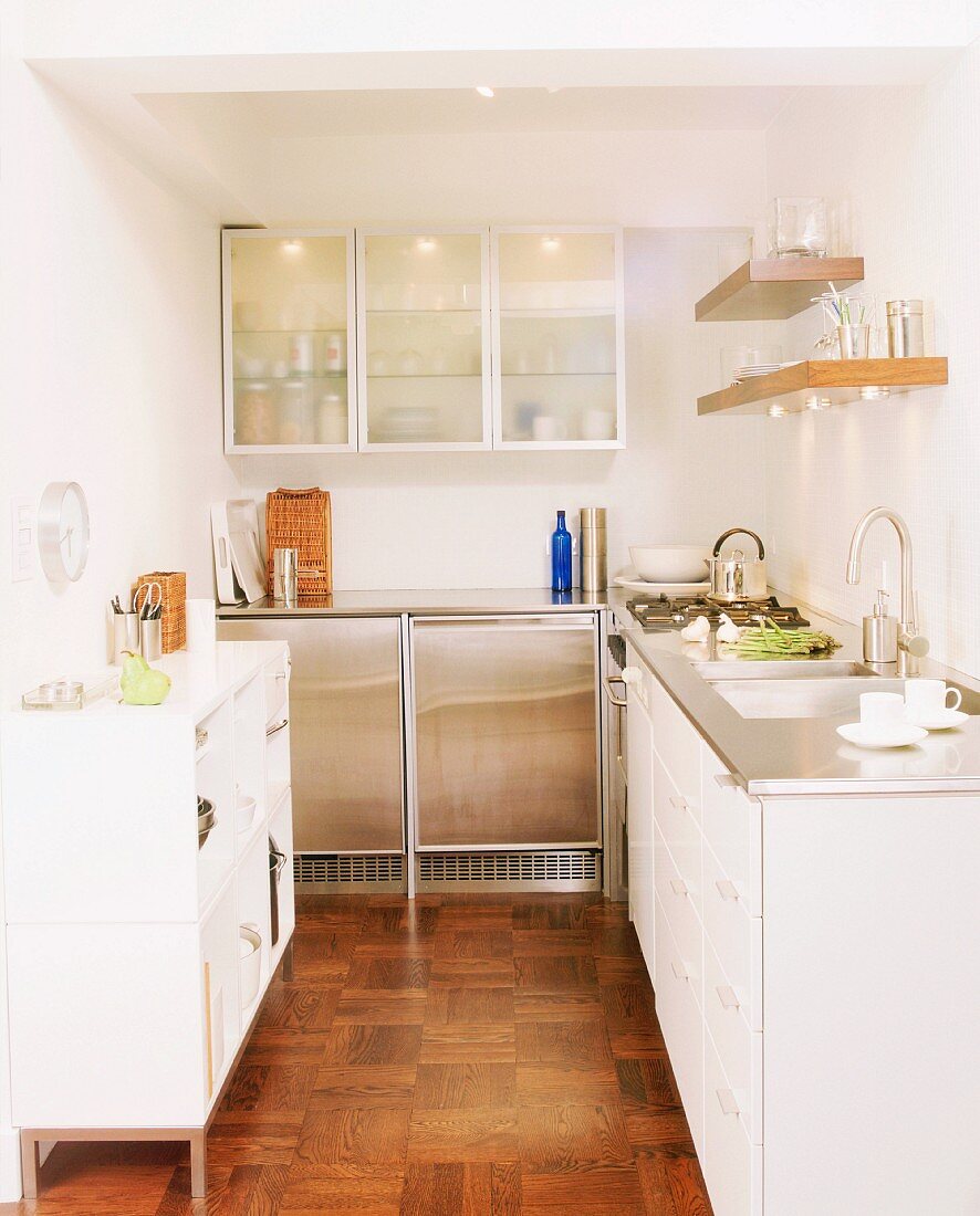 L-shaped kitchen counter with white and stainless steel doors