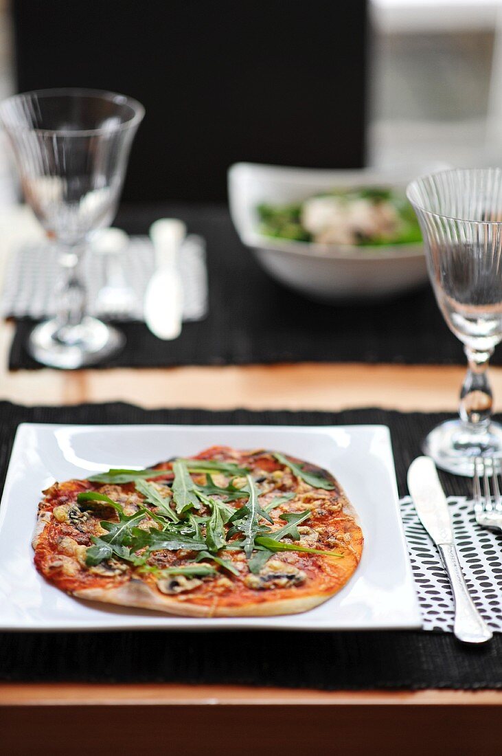 A mushroom and rocket pizza