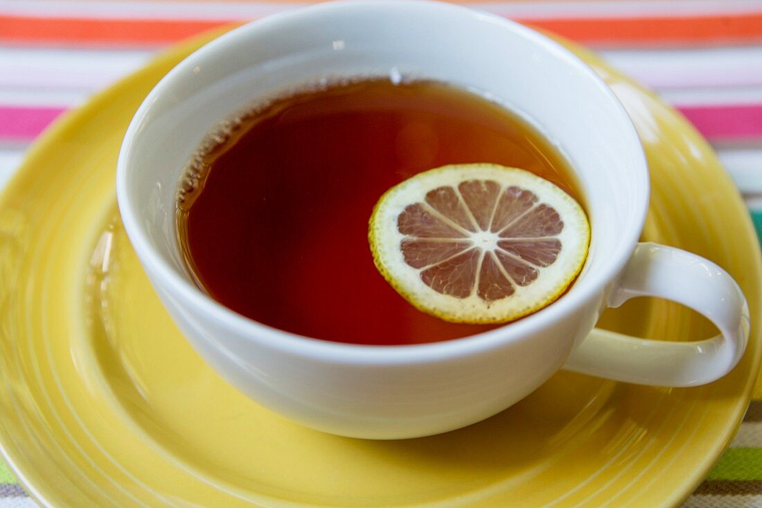 A cup of black tea with lemon