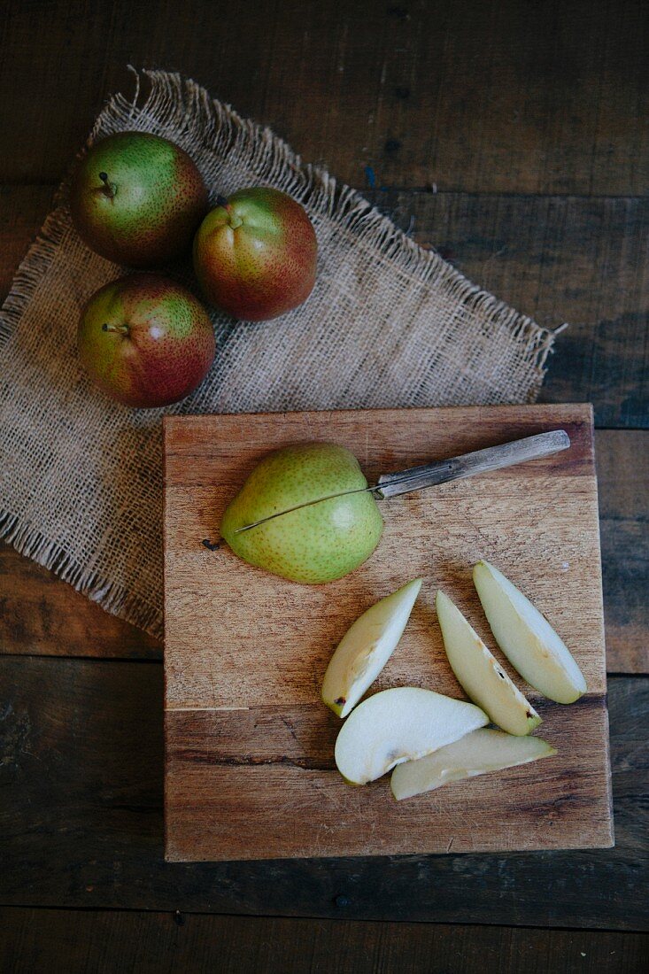 An arrangement of pears featuring whole pears and pear wedges