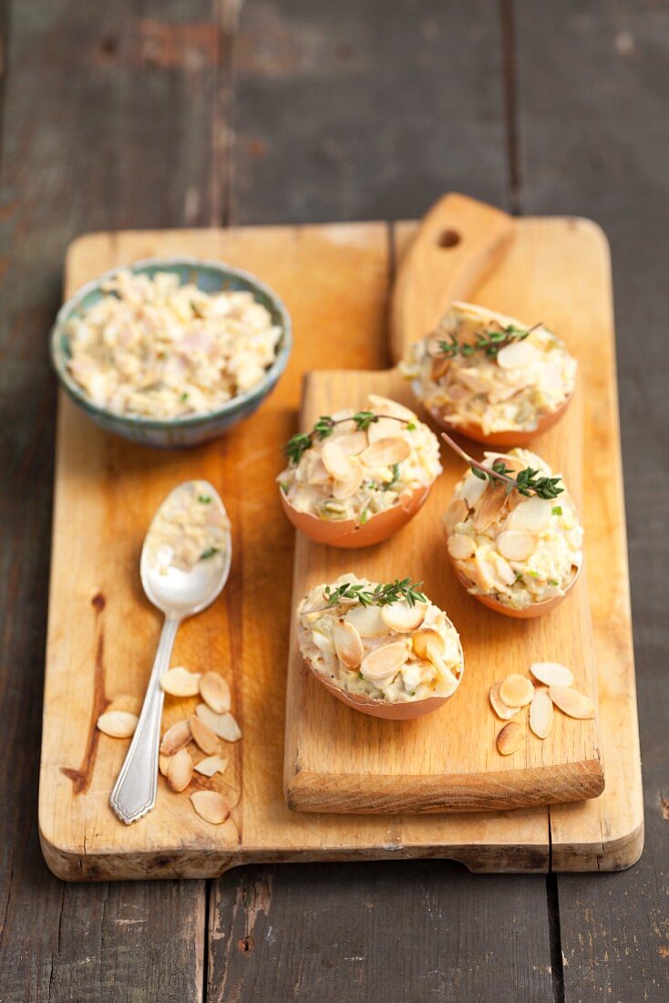 Egg salad with slivered almonds served in eggshells