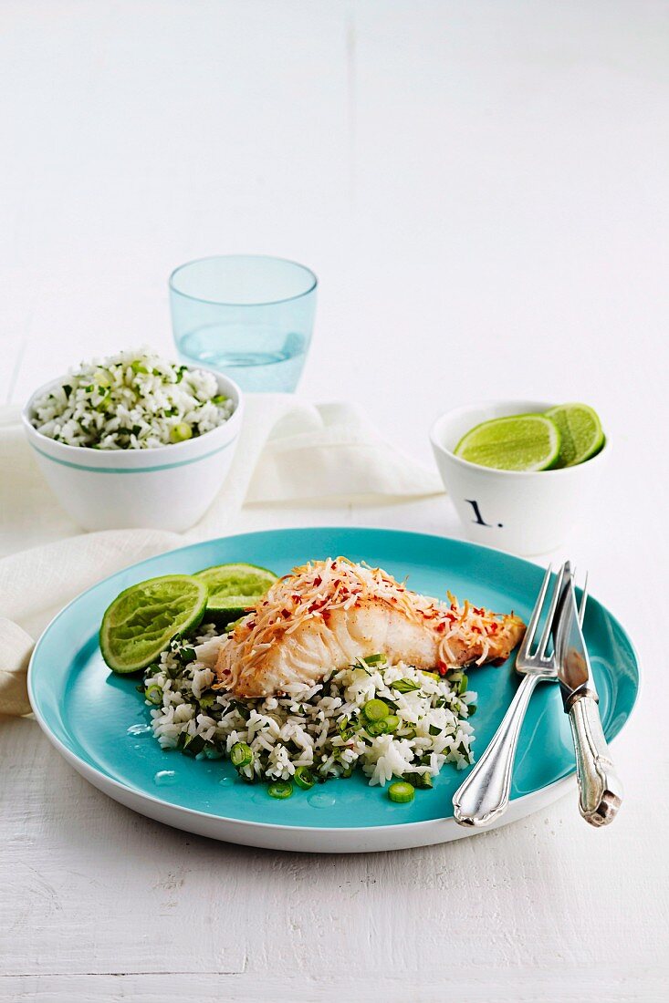 A fillet of fish with a coconut crust on a bed of herb rice