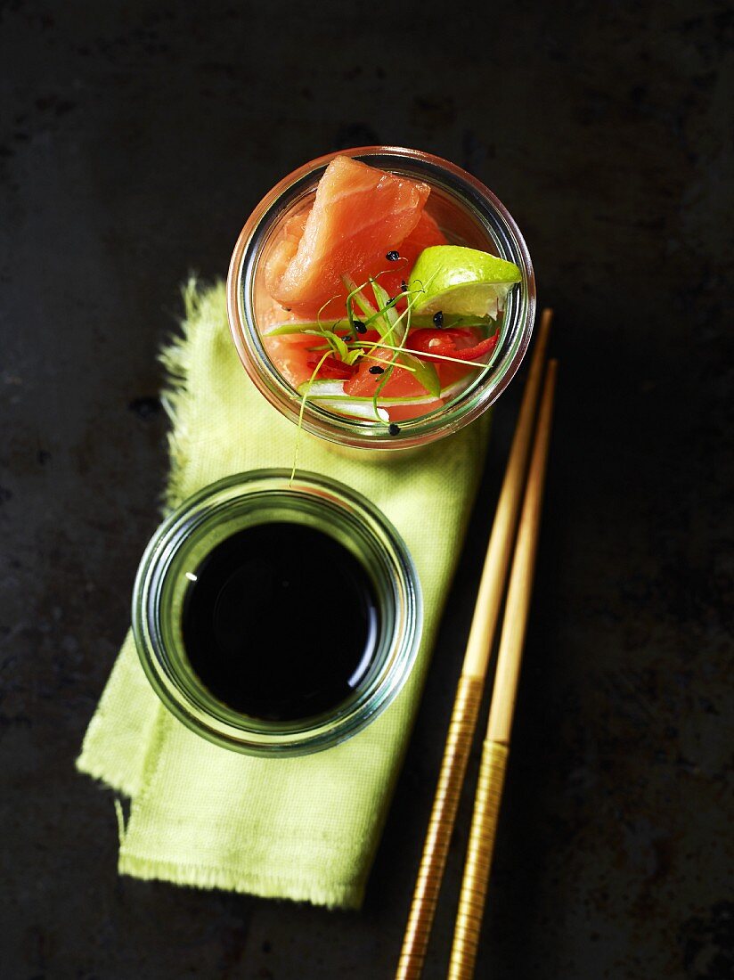 Salmon sashimi and soya sauce on small glass bowls (Japan)