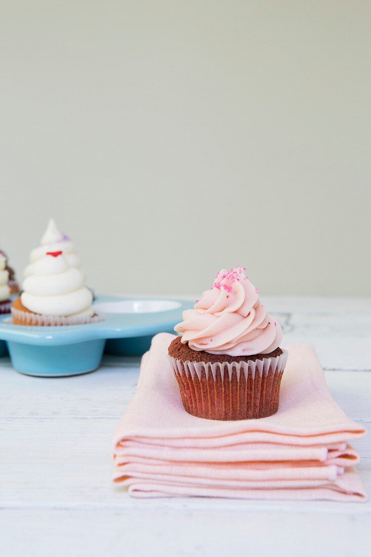 A strawberry cupcake with frosting