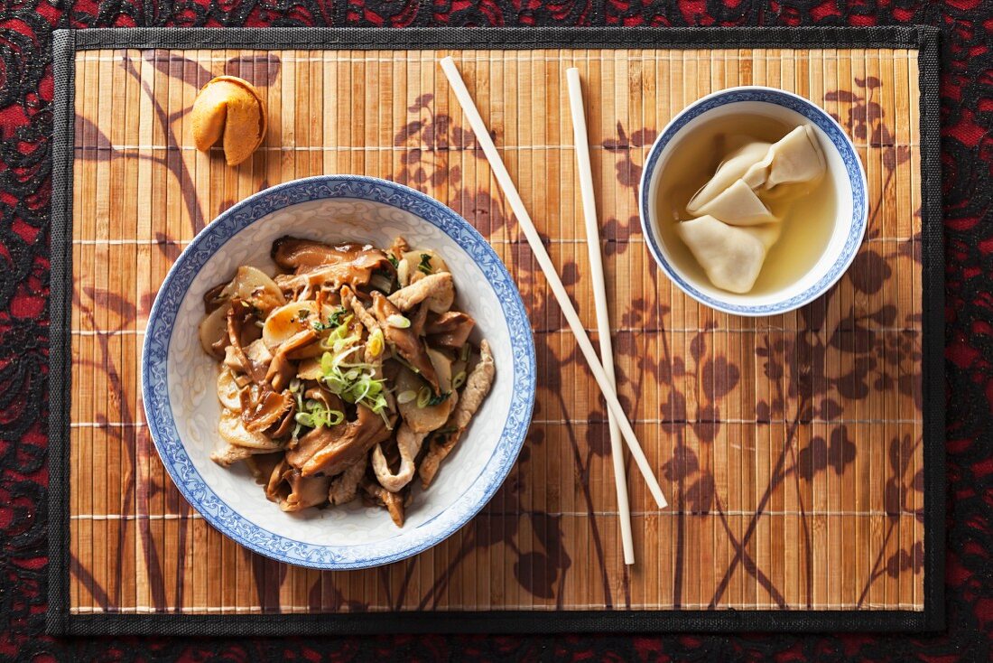 Chinese pork and mushrooms with a bowl of wonton soup