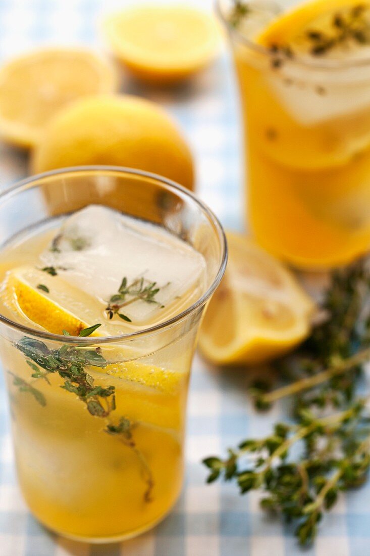 Homemade lemonade with thyme, lemon and ice cubes