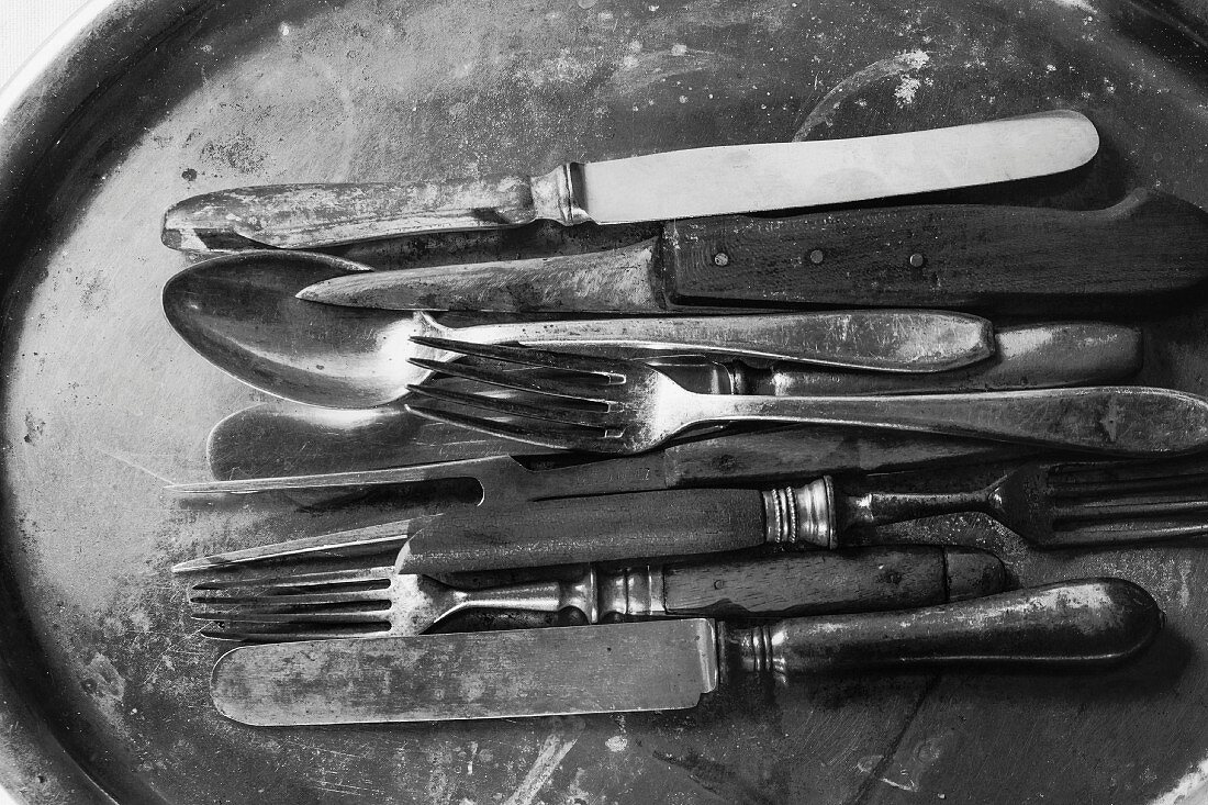 Knives and forks on a vintage tray
