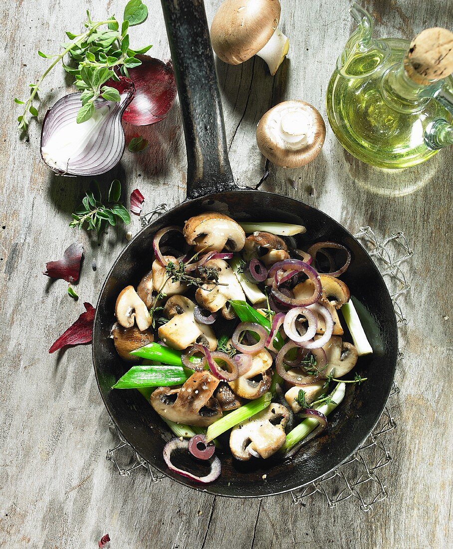 Fried mushrooms with red onions, spring onions, thyme marjoram and olive oil
