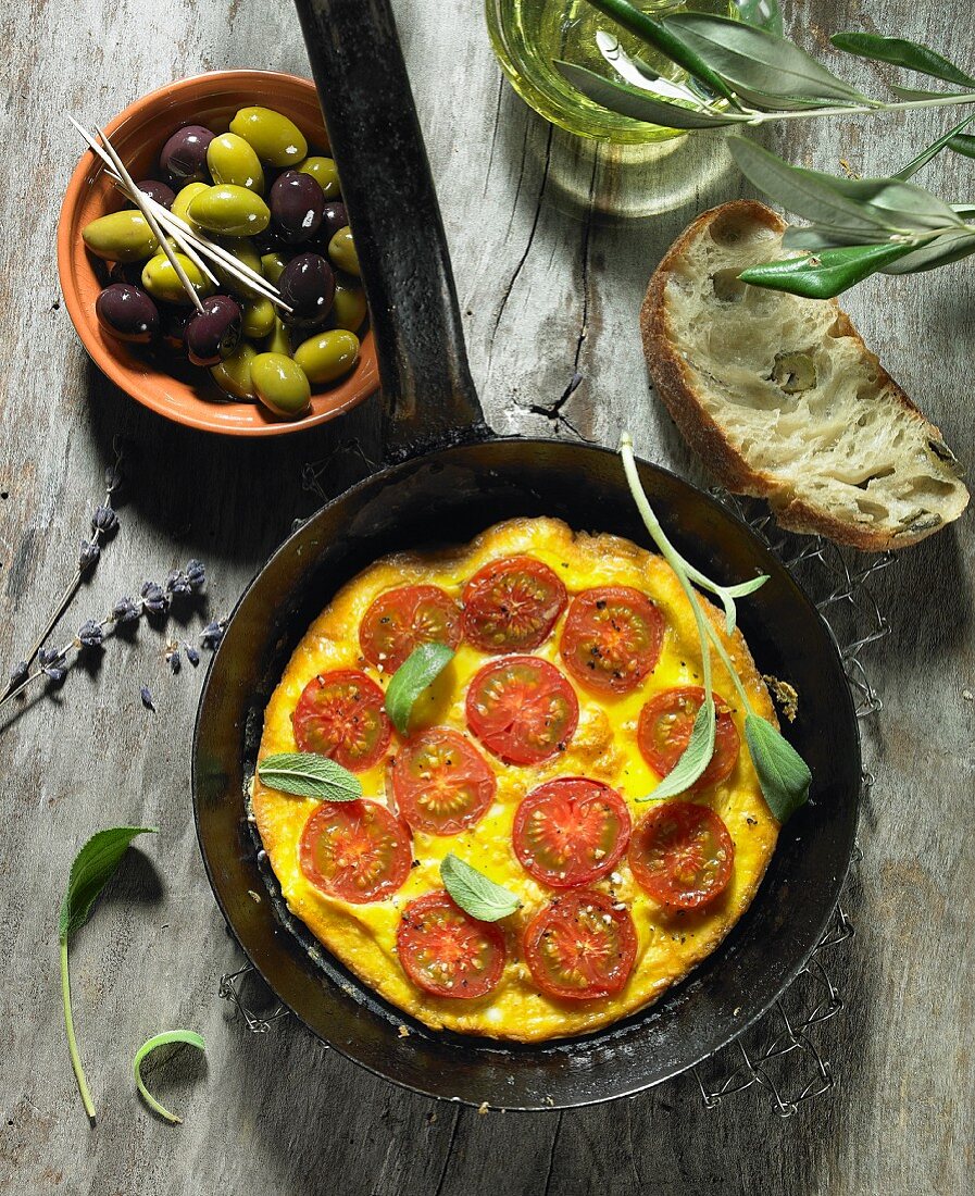 A tomato omelette with sage, black and green olives, olive oil, an olive spring, olive ciabatta and lavender