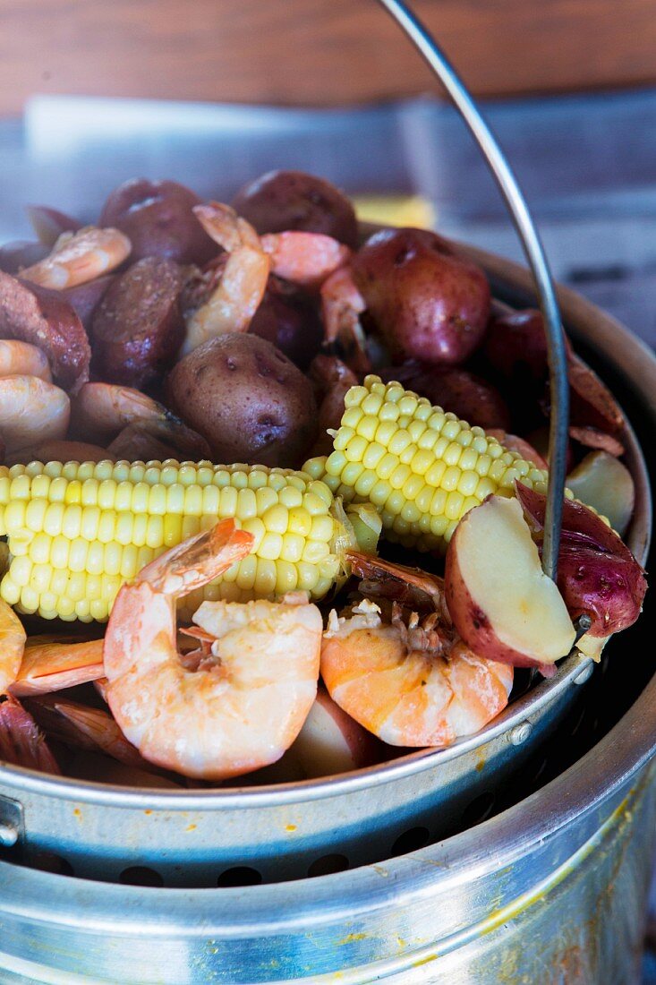 Stew made with sweetcorn, potatoes, sausages and prawns