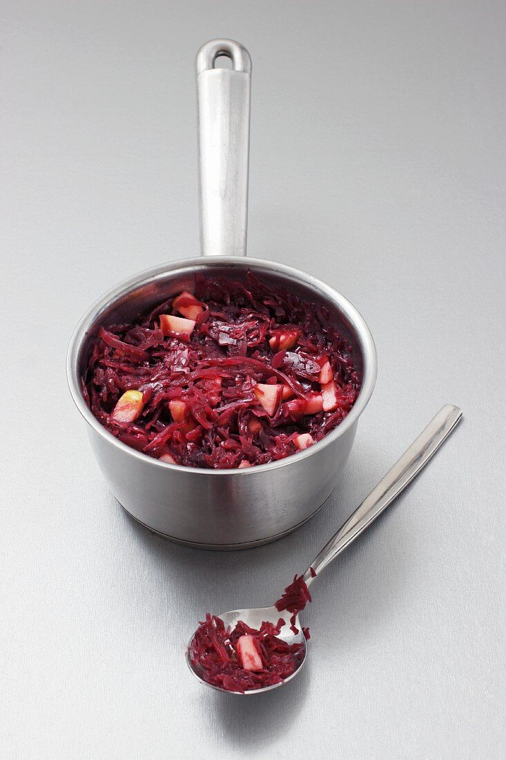 Apple-red cabbage in a pan and on a spoon