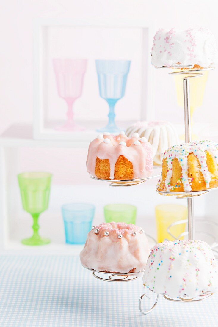 Mini Bundt cakes decorated with icing sugar and sugar pearls for a child's birthday party