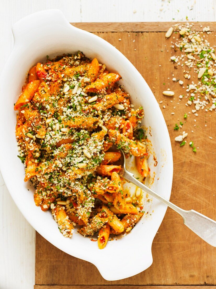 Gratinated penne with tomatoes, breadcrumbs and pine nuts