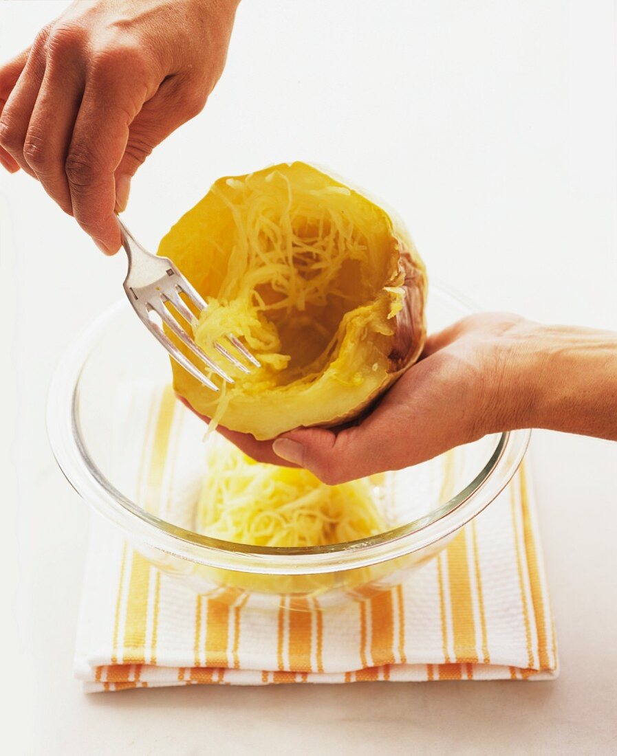 Flesh being scraped out of a spaghetti squash