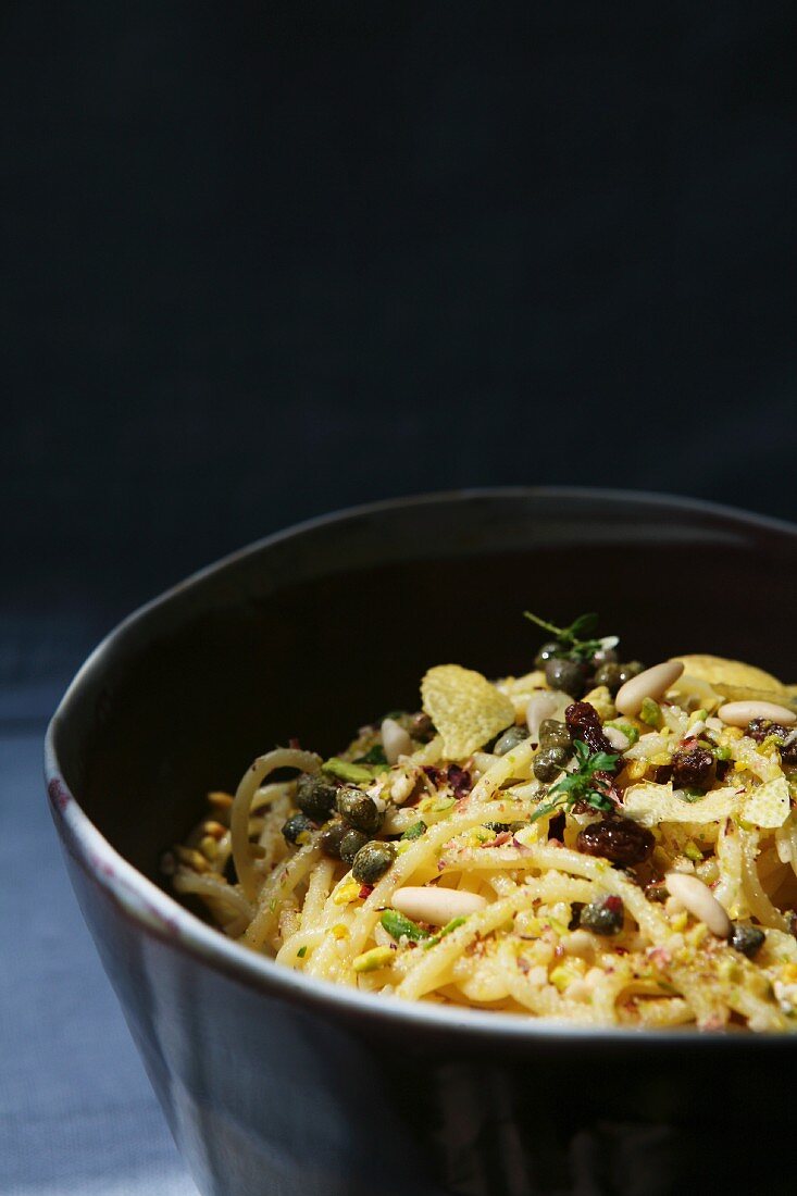 Pasta al limone (spaghetti with lemons, capers, raisins and pine nuts)