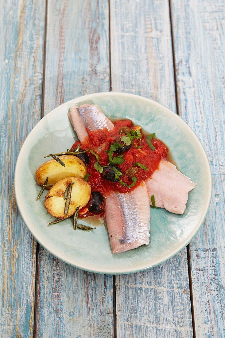 Soused herring fillets with tomato sauce, olives and rosemary potatoes