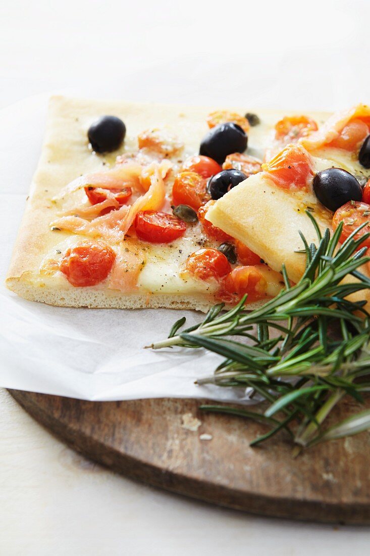 Salmon, cherry tomato and olive pizza