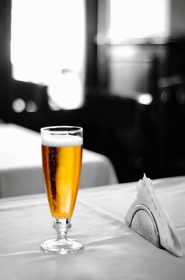 A glass of lager on a table in an Italian bar