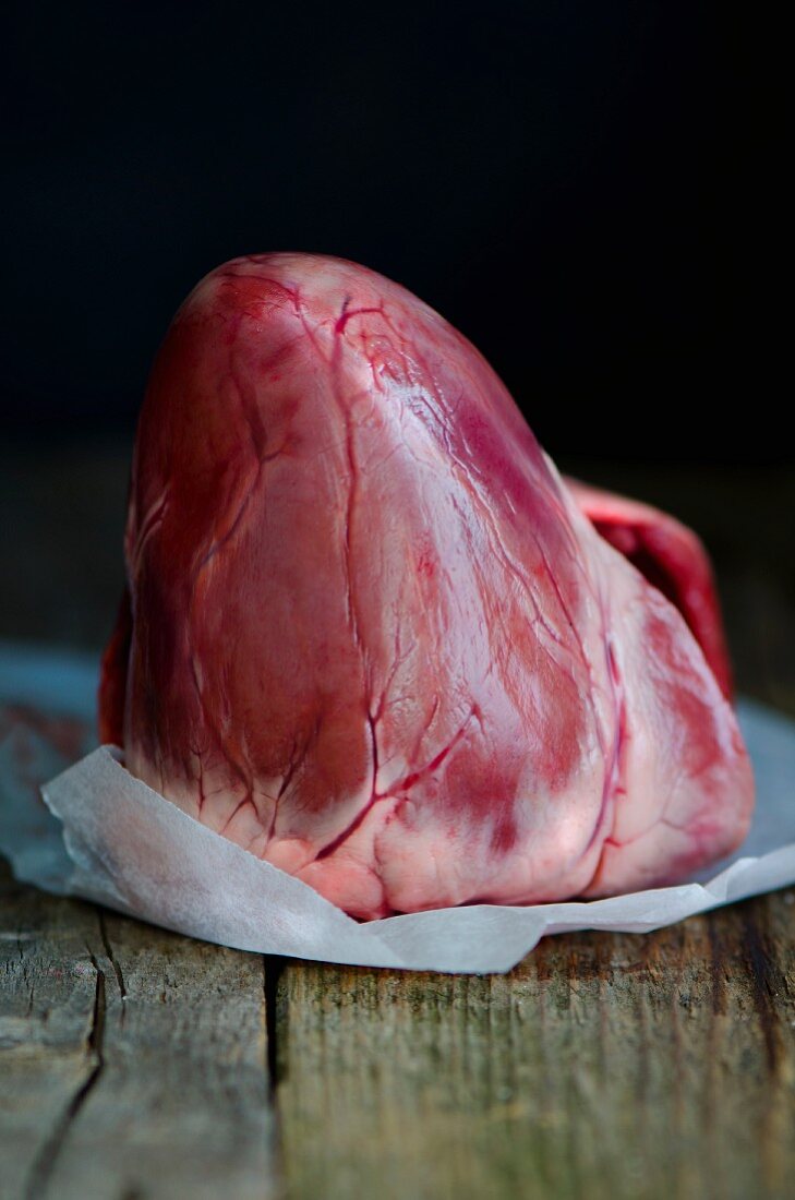 A whole pig's heart on a piece of greaseproof paper